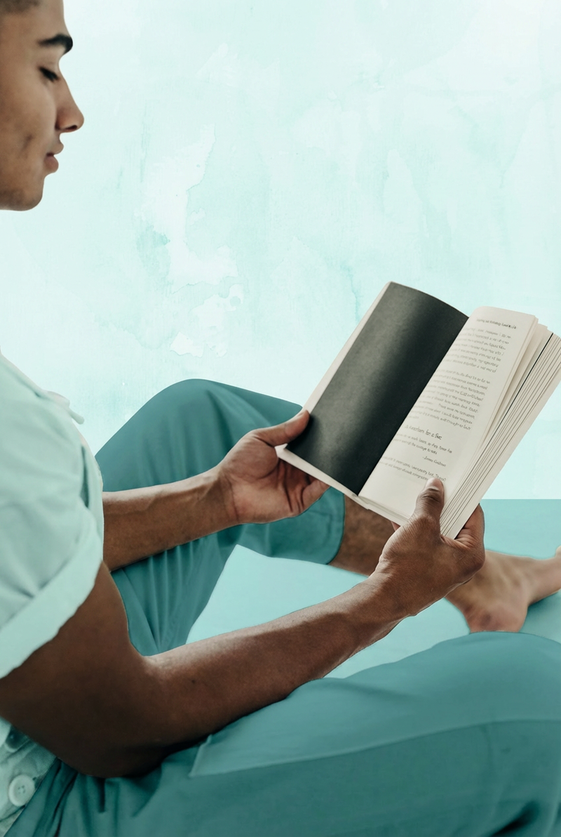 Man relaxed and reading a book, representing the role of Magnesium L-Threonate in supporting cognitive function, focus, and mental clarity.